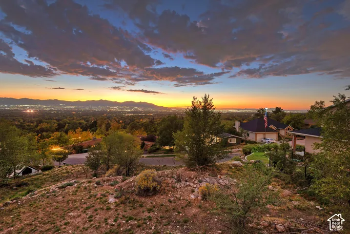 Expansive elevated property with distant city lights and mountains
