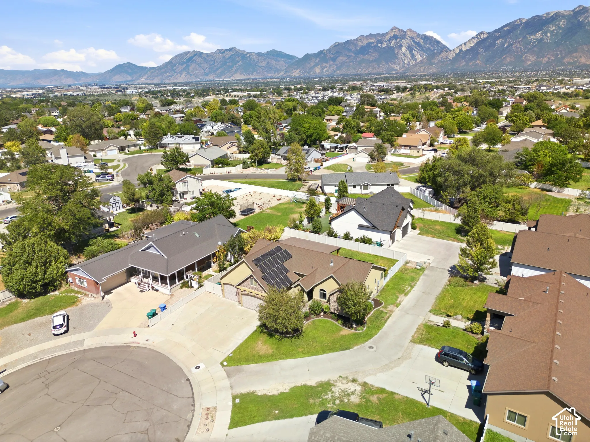 Mountain backdrop with residential properties and abundant trees