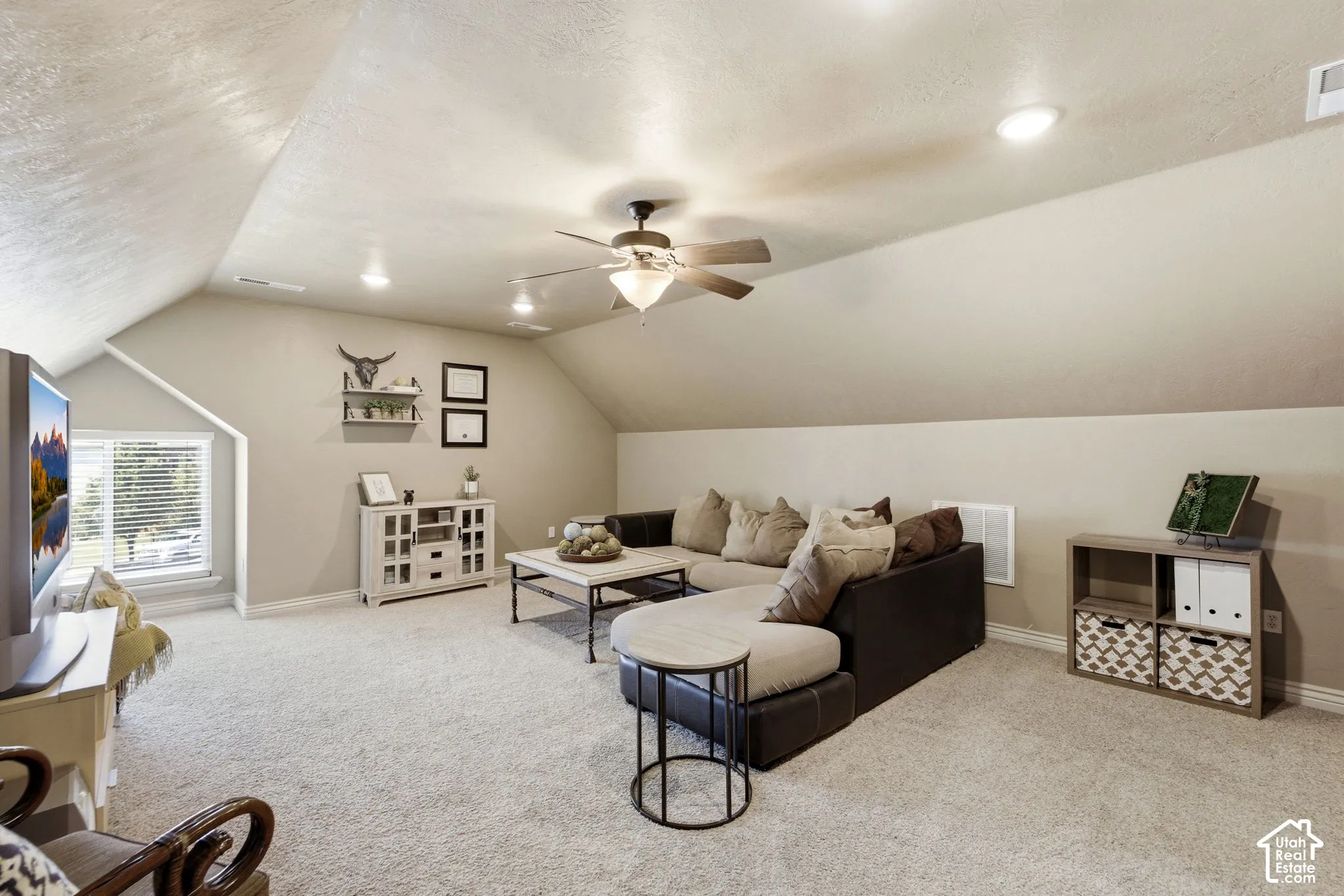 Carpeted bonus room featuring sloped ceilings, recessed lighting, and a ceiling fan