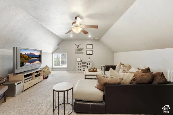 Spacious bonus room featuring sloped ceilings, recessed lighting, and a ceiling fan