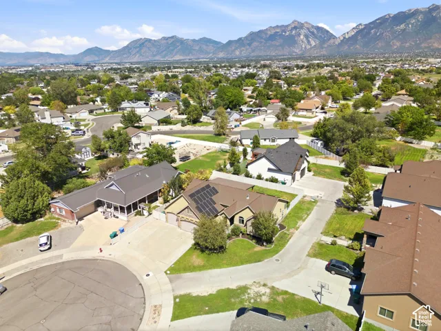 Mountain backdrop with residential properties and abundant trees