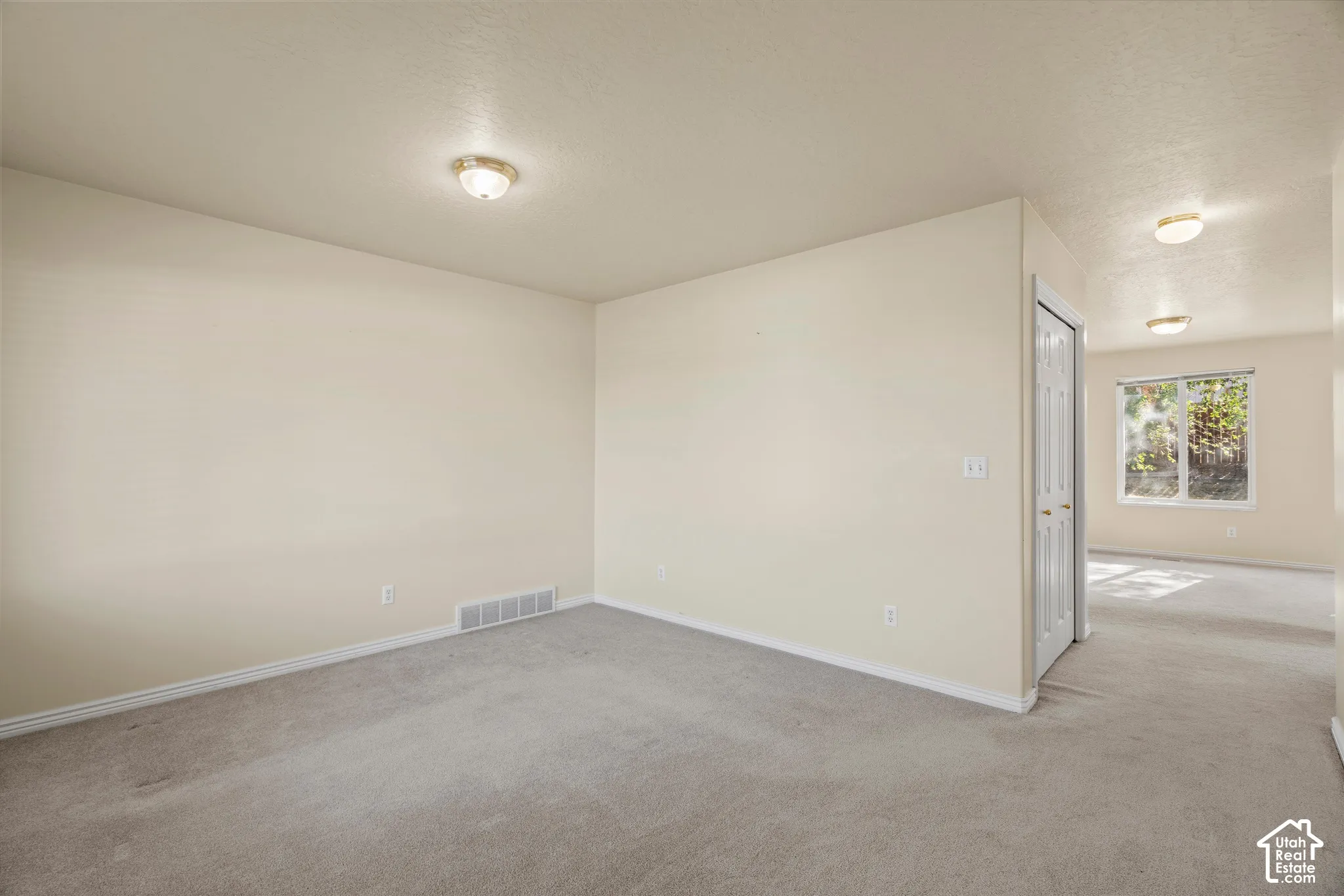 Neutral-toned walls complement plush carpeting