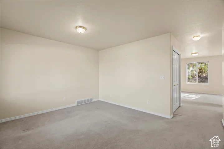 Neutral-toned walls complement plush carpeting