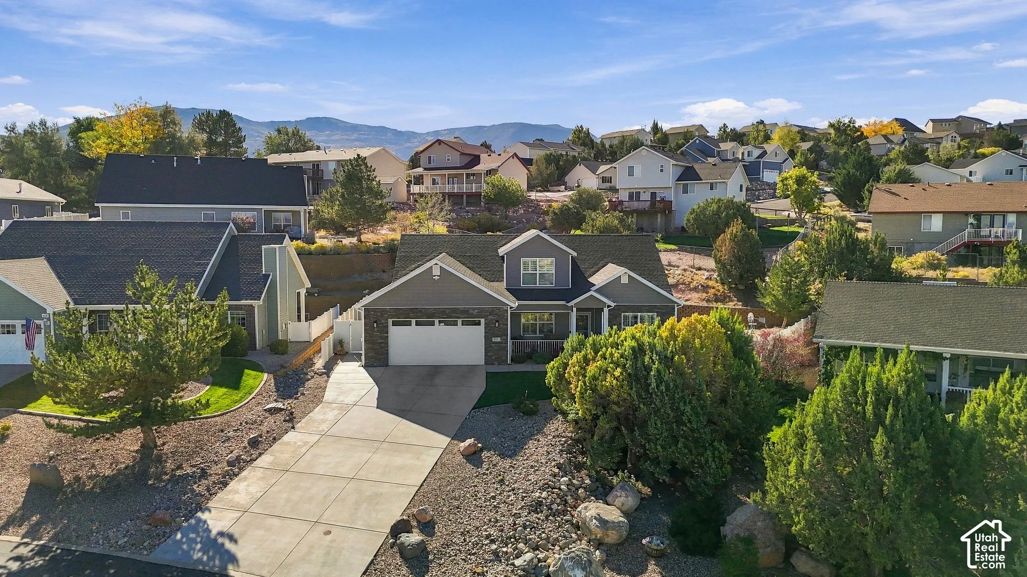 Contemporary home with a two-car garage, concrete driveway, and a partially landscaped front yard