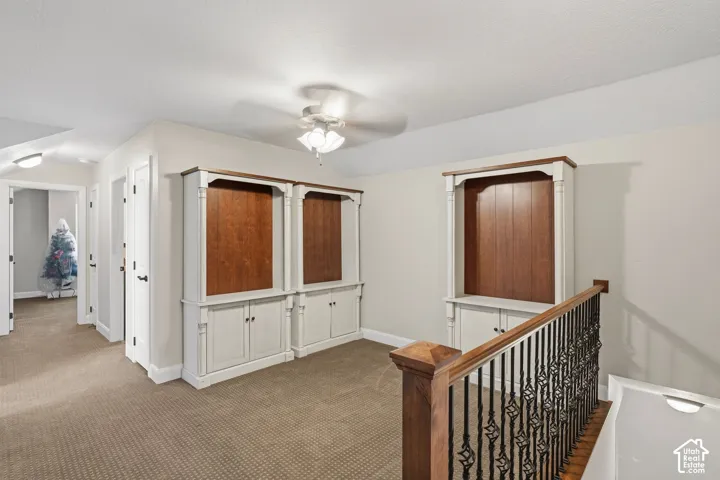 Built-in cabinetry with wood-finish backing and cream-colored lower storage