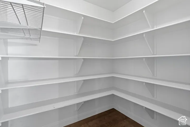 Built-in white shelving, wood-finish flooring, and a wire rack