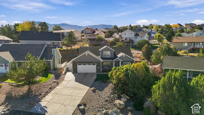 Contemporary home with a two-car garage, concrete driveway, and a partially landscaped front yard