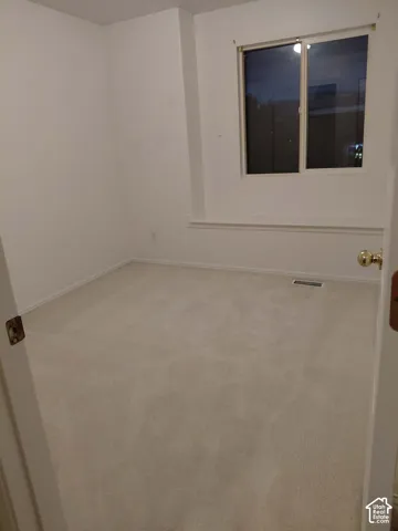 Wall-to-wall carpeting and white painted walls
