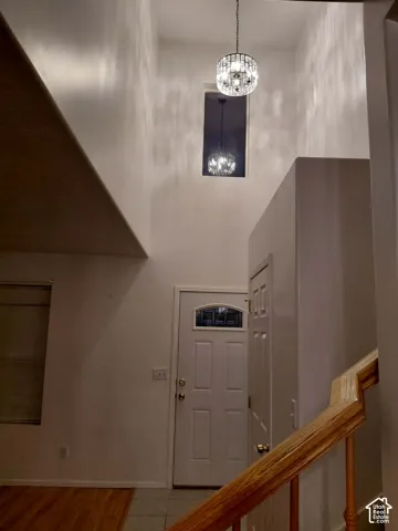 Two-story entryway featuring a decorative chandelier and an arched transom above the front door