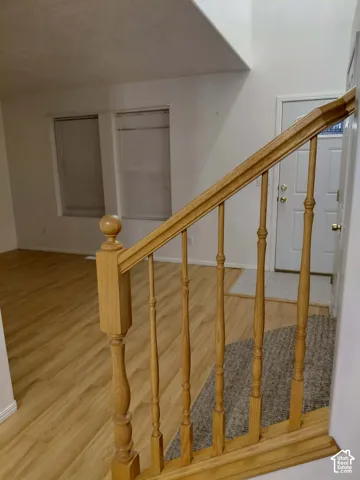 Light wood-finish flooring with white baseboards