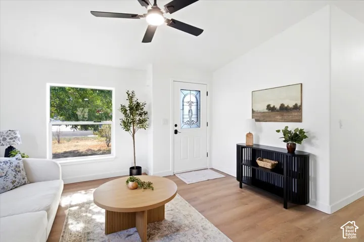 Smooth wood-finish flooring with white walls