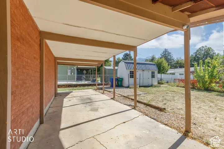Covered concrete patio with brick exterior