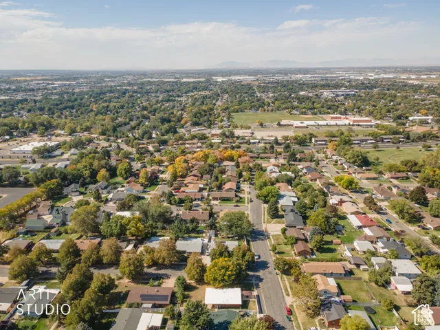 Residential neighborhood setting with established tree canopy and distant mountain range