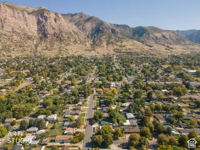 Neighborhood setting with mature trees and mountain backdrop