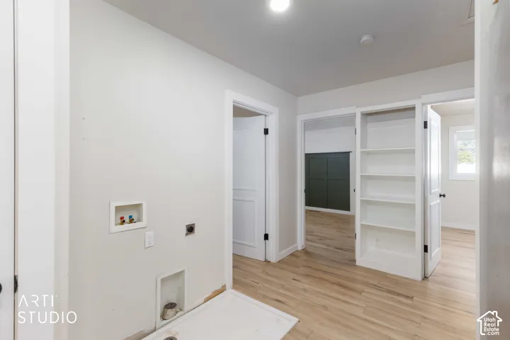 Wood-finish flooring throughout, white interior doors, built-in shelving, and recessed lighting