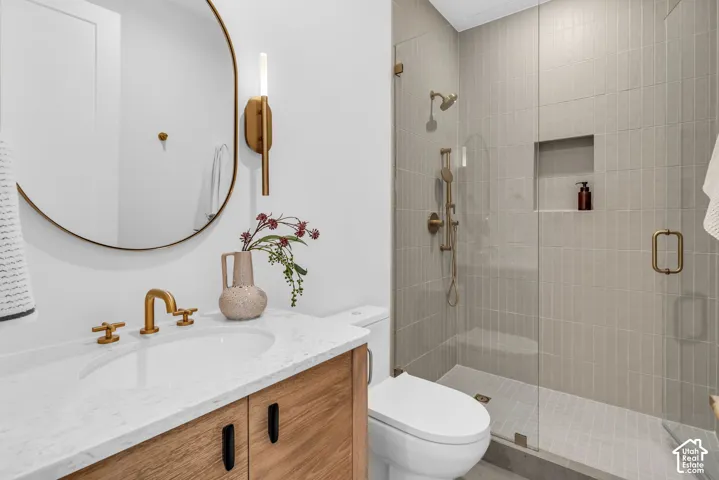 Custom wood-finish vanity with a white countertop and brass-finish fixtures