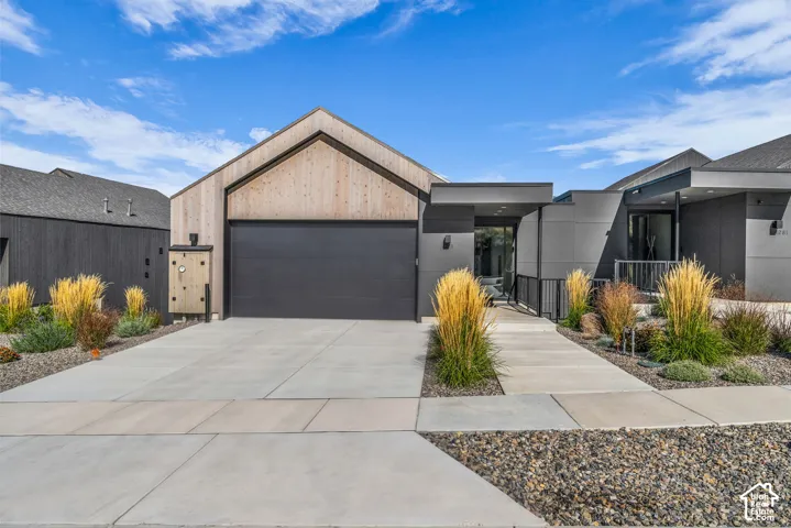 Contemporary architecture featuring a dark gray facade and natural wood-finish accents