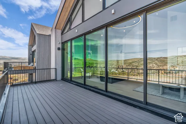 Spacious outdoor deck with composite decking and black metal railings