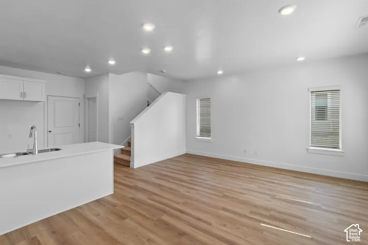 Recessed lighting illuminating wood-finish flooring