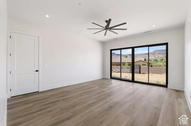 Wood-finish flooring, recessed lighting, and a modern ceiling fan