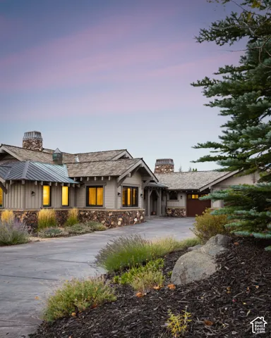 Craftsman-style exterior with wood shake roofing, stone accents, and board-and-batten siding