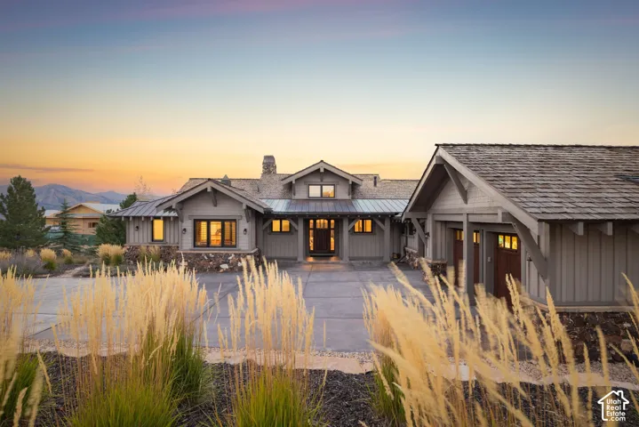 Craftsman-style exterior with stone accents, shake roofing, and a prominent chimney