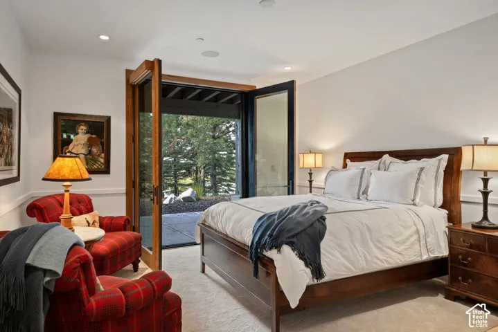Recessed lighting, wood-framed glass doors, and light-colored carpeting
