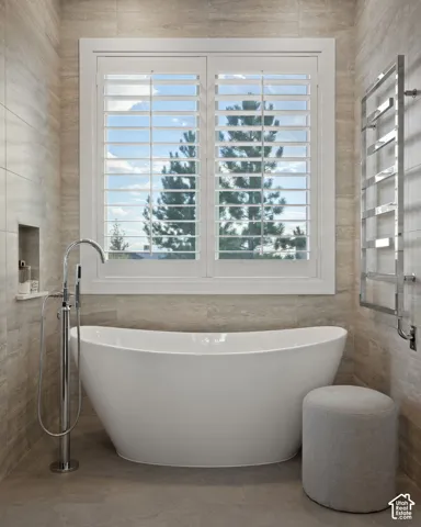 Freestanding soaking tub with floor-mounted chrome fixture