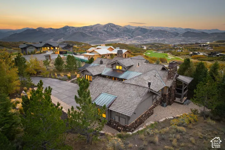 Extensive property featuring multiple structures, a stone and wood exterior, and a multi-level roofline