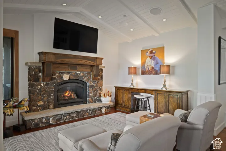 Stone-clad fireplace with a wood mantel and arched firebox