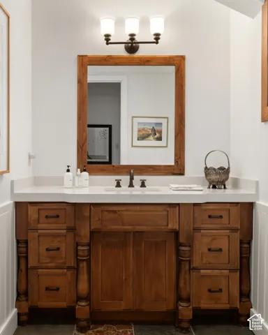 Wood vanity with a white countertop and integrated sink