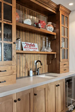 Custom wood cabinetry with glass-front display cases and integrated shelving