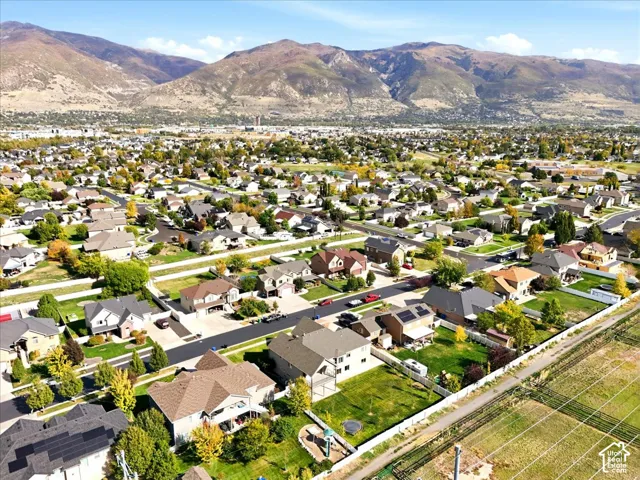 Residential neighborhood with a mountain backdrop, mature trees, and a mix of single-family homes