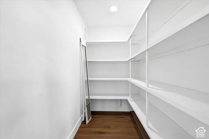 Built-in shelving, recessed ceiling lighting, and wood-finish flooring