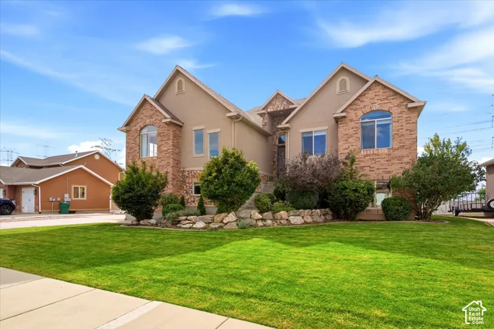 Stucco and brick exterior with arched and rectangular windows