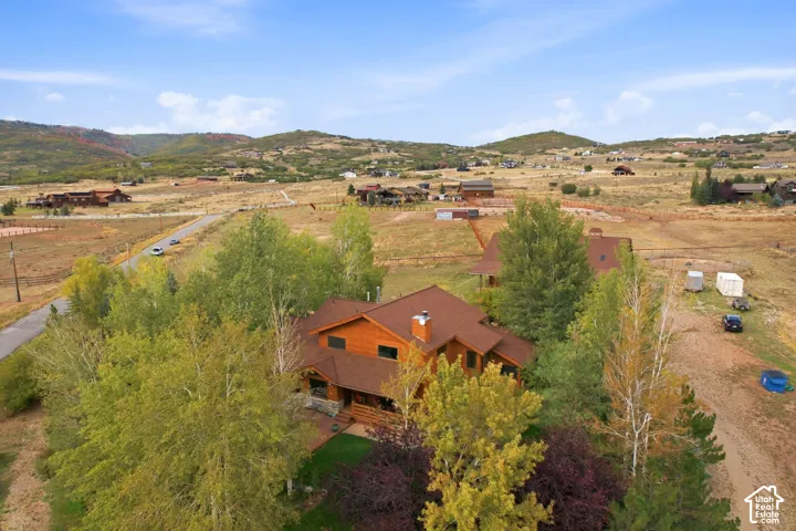 Wood-sided residence with multiple gables and a stone accent chimney