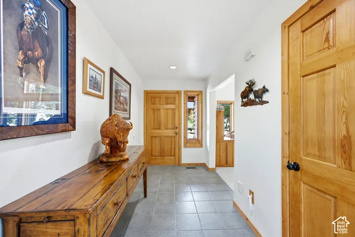 Wood panel doors, tiled flooring, recessed lighting, and wood-trimmed windows