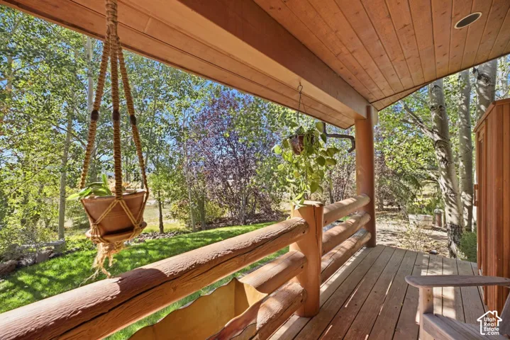 Wood-finish porch decking with a log railing
