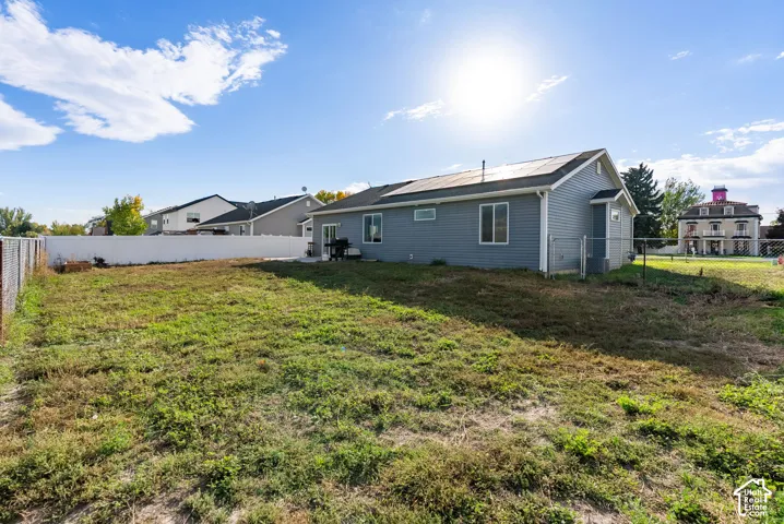 Expansive backyard featuring a partial chain-link fence and partial privacy fence
