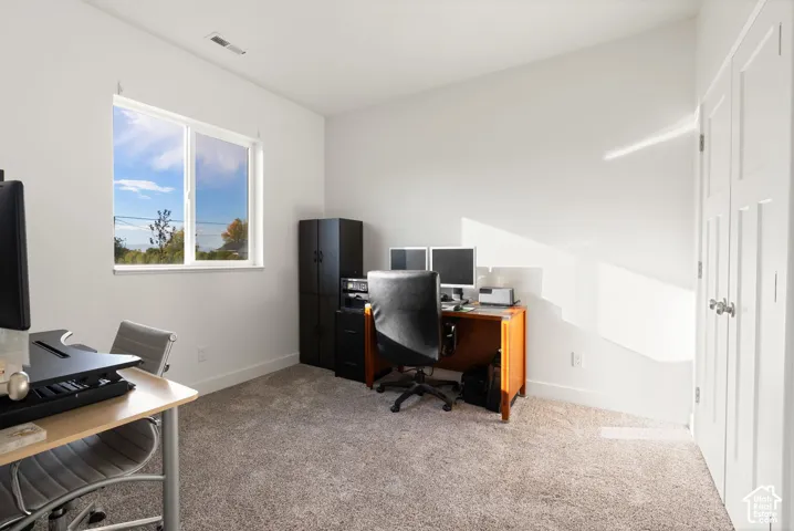 White interior walls, white trim, and light-colored carpeting
