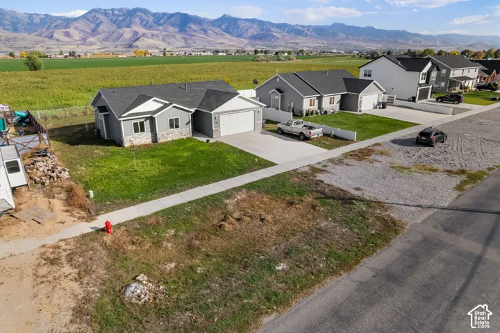 Contemporary ranch-style residence featuring a gray exterior with stone accents and white trim