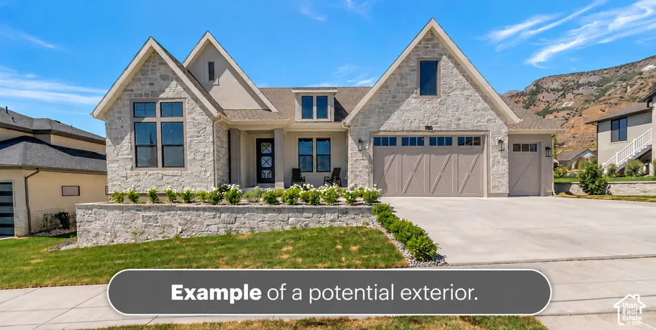 Stone veneer exterior featuring a multi-gabled roofline, three-car garage with decorative paneling, concrete driveway, and elevated landscaping retaining wall