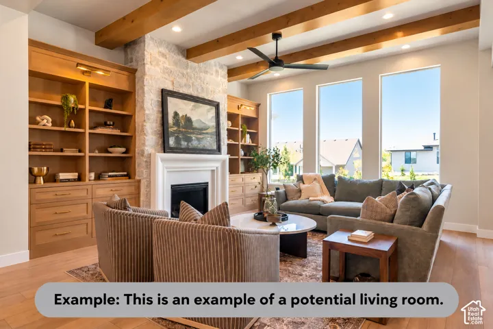 Stone-clad fireplace with a white mantel, built-in wooden shelving, a ceiling fan, exposed wood beams, and large windows