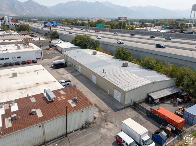 Industrial building with multiple bay doors, metal siding, and a corrugated metal roof