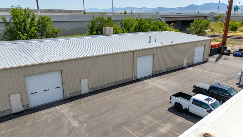 Industrial building with a metal roof and tan siding