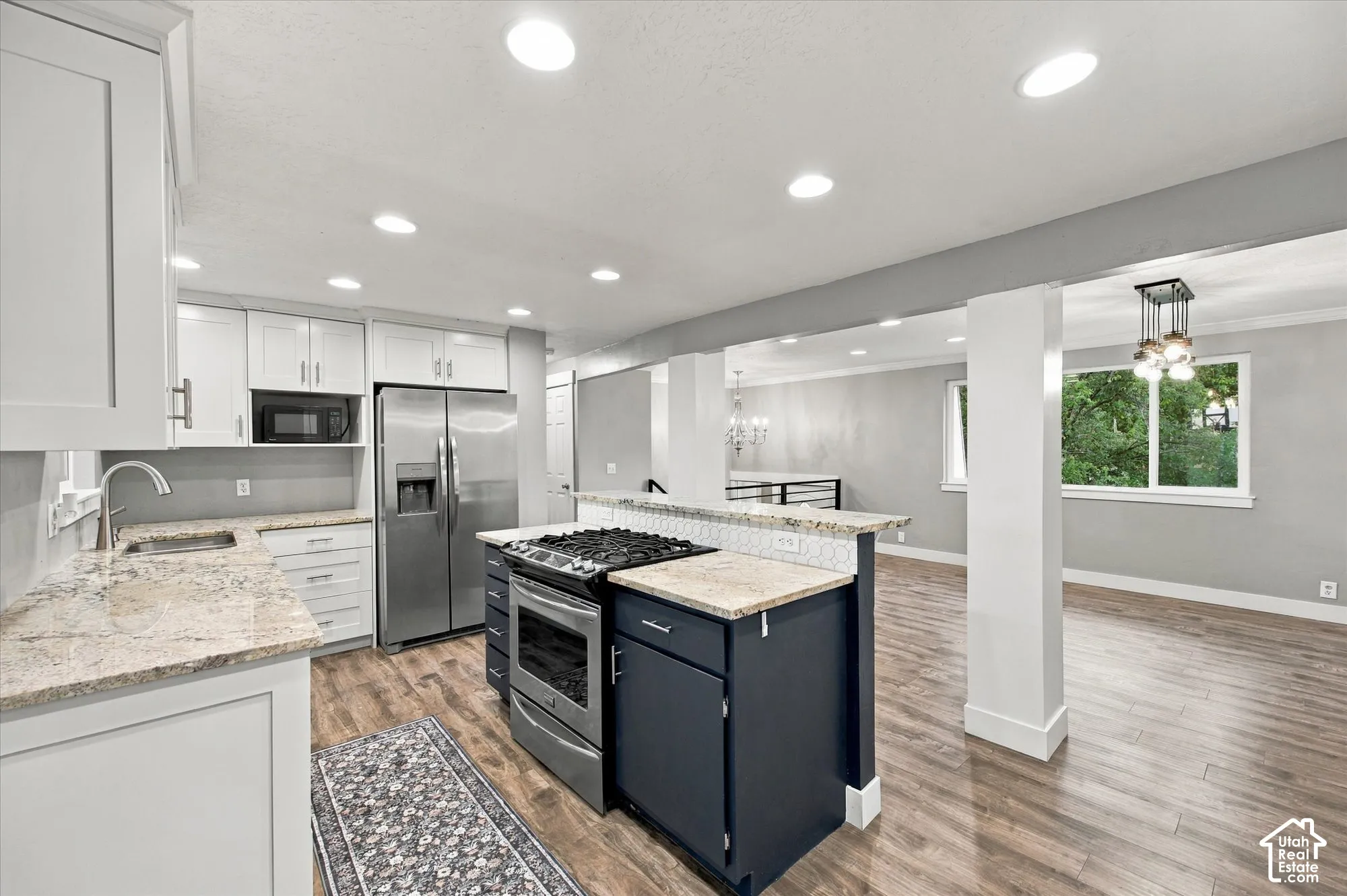 Kitchen featuring white cabinetry, stainless steel appliances, Granite countertops.