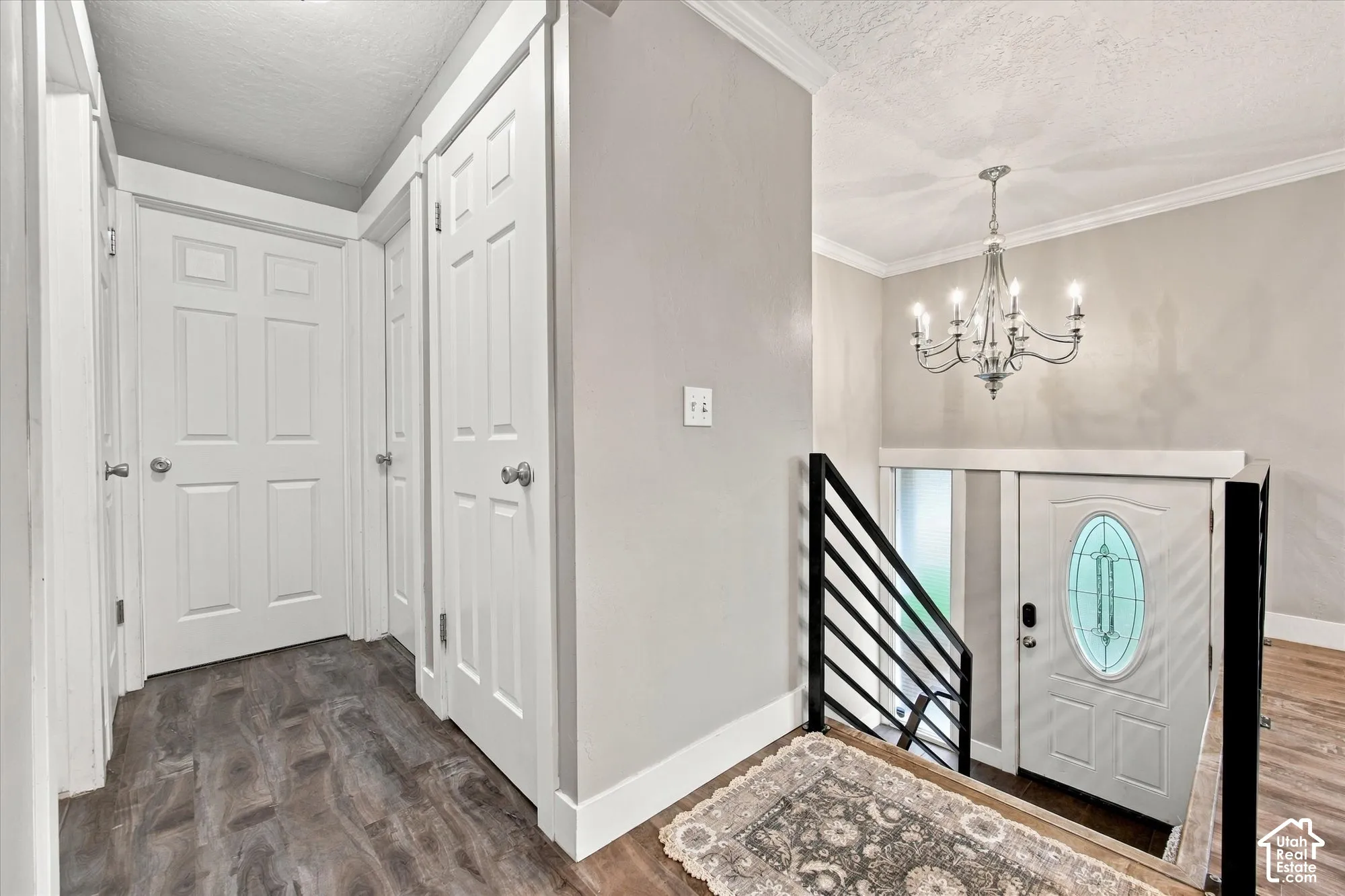 LVP flooring throughout, white paneled doors, and a decorative chandelier