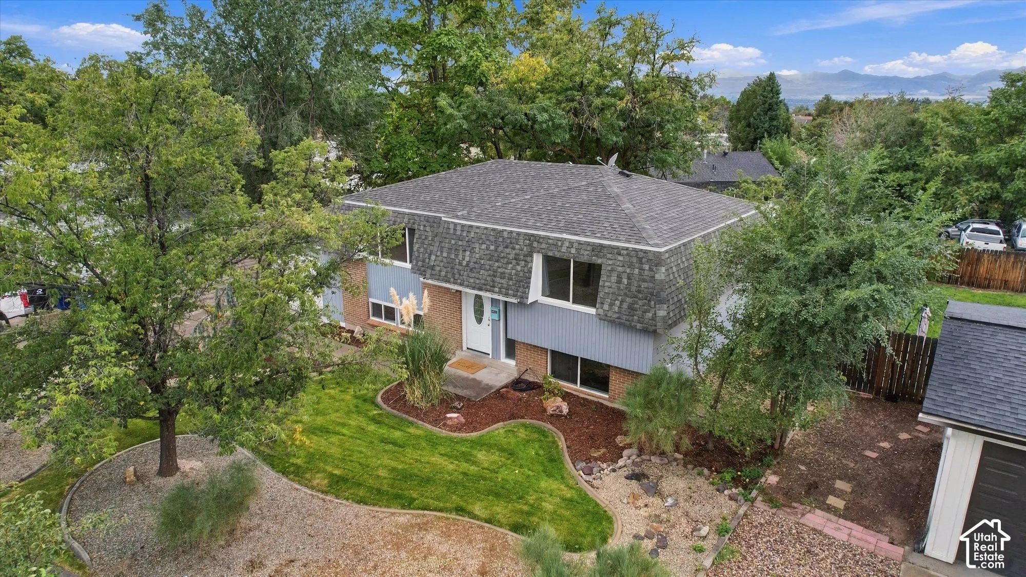 Two-story residence with a gambrel roof and light blue siding