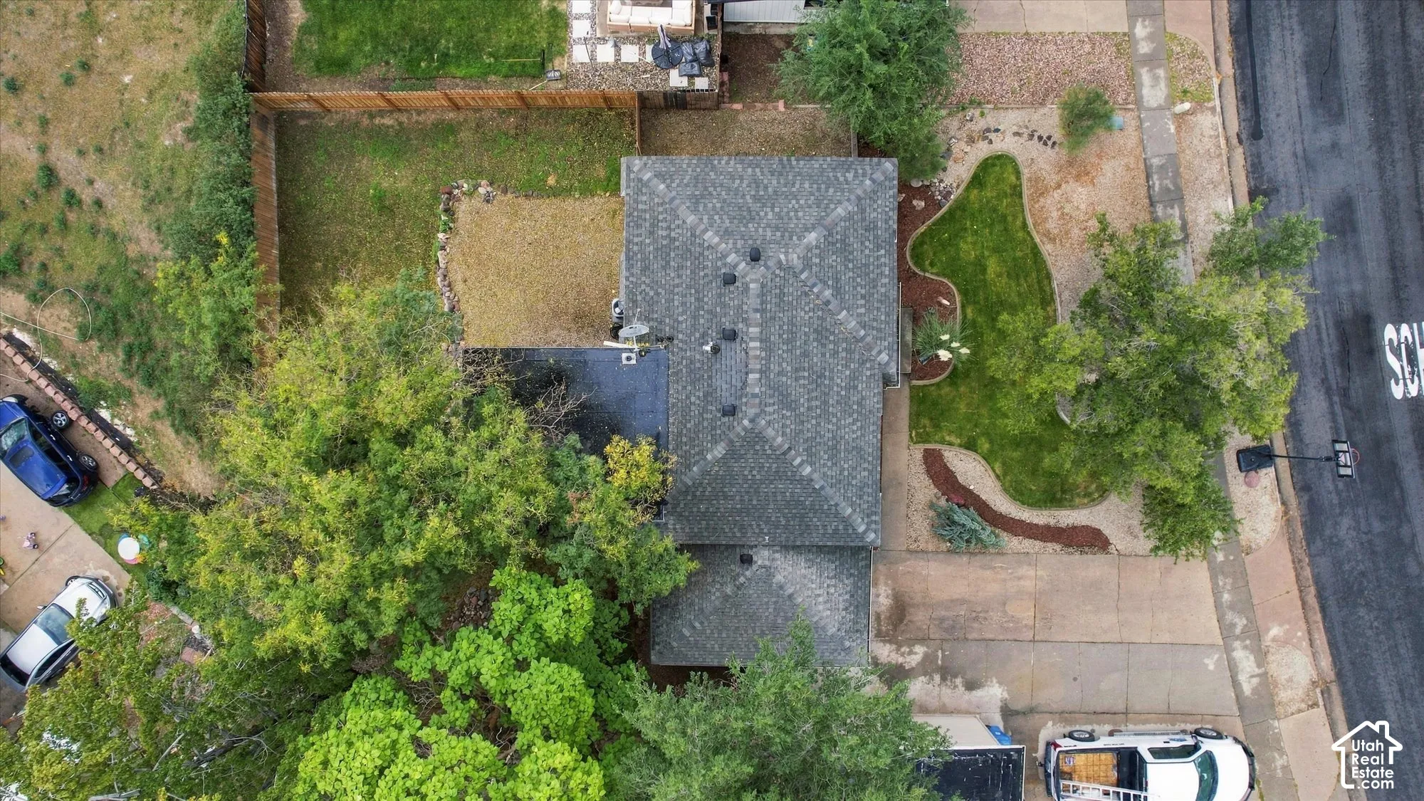 Asphalt shingle roof, established trees, fenced yard, front yard landscaping, paved driveway