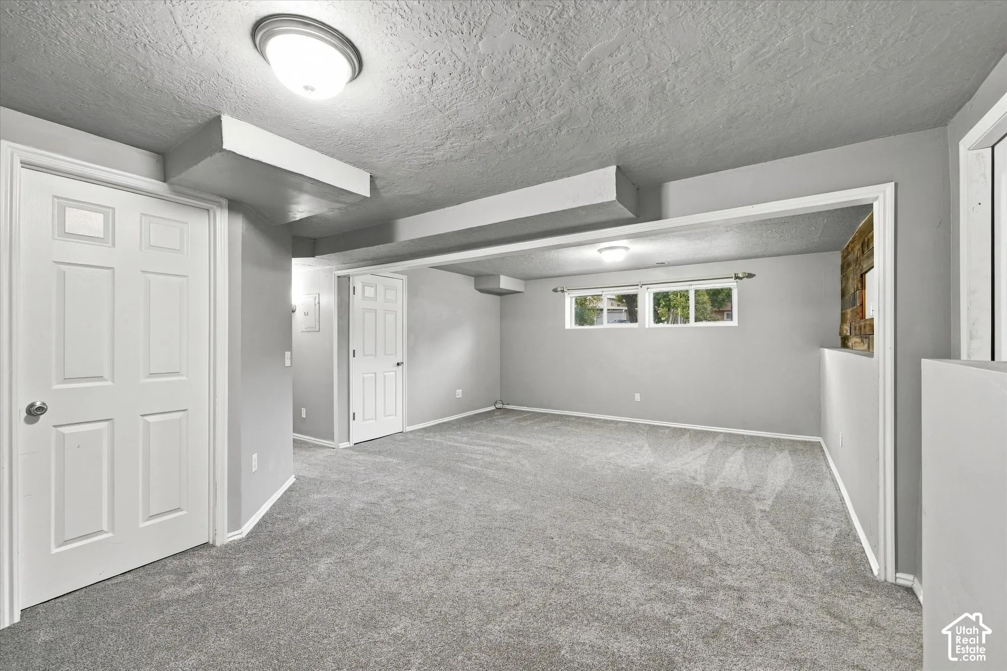 Carpeted flooring, recessed lighting, multiple windows, and paneled interior doors